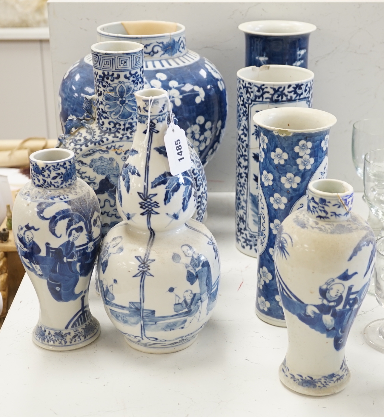 A Chinese blue and white Buddhist lion moon flask, a baluster vase, three sleeve vases and two others, 19th century, tallest 33cms (a.f.)